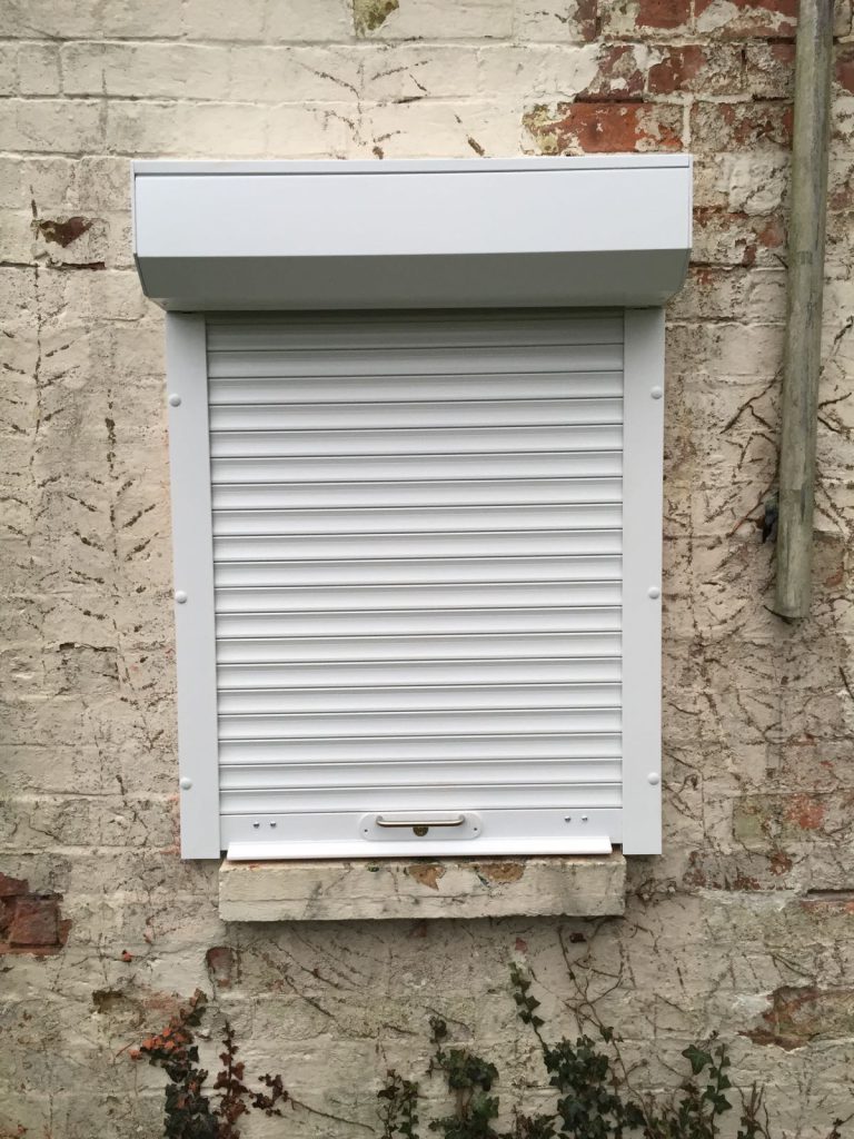 white domestic security shutters installed in Oxford by Shutter Spec Security - house view